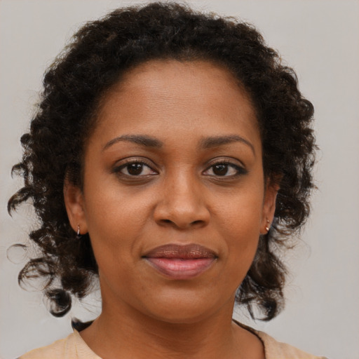 Joyful black young-adult female with medium  brown hair and brown eyes