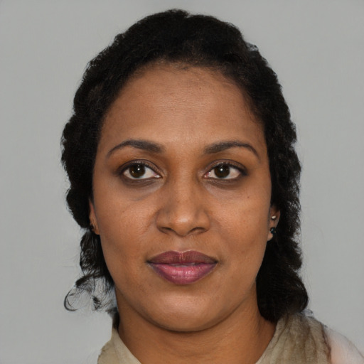 Joyful black adult female with short  black hair and brown eyes