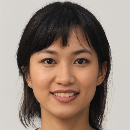 Joyful asian young-adult female with medium  brown hair and brown eyes