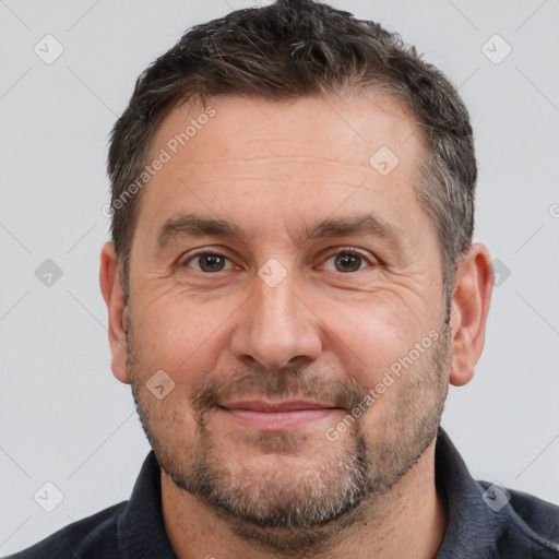 Joyful white adult male with short  brown hair and brown eyes