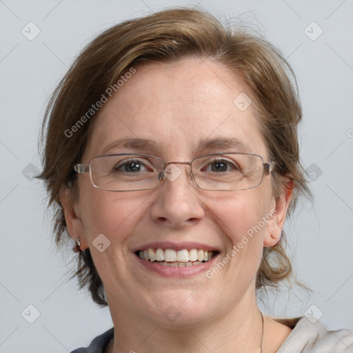 Joyful white adult female with medium  brown hair and blue eyes