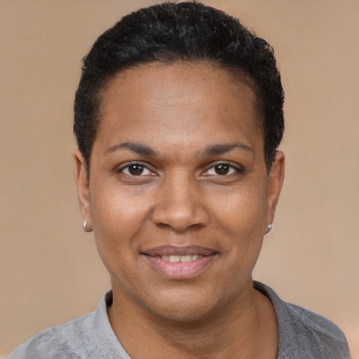 Joyful black young-adult female with short  black hair and brown eyes