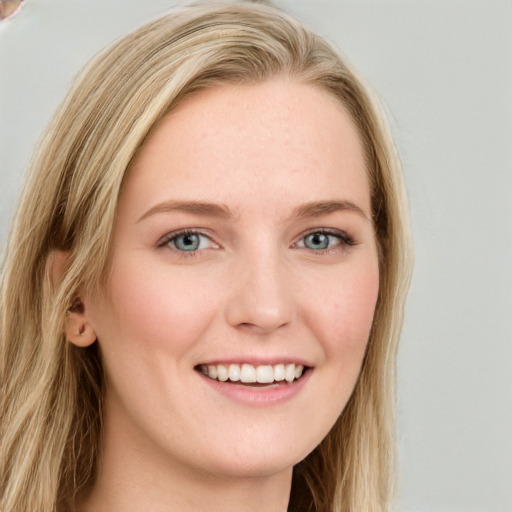 Joyful white young-adult female with long  brown hair and blue eyes