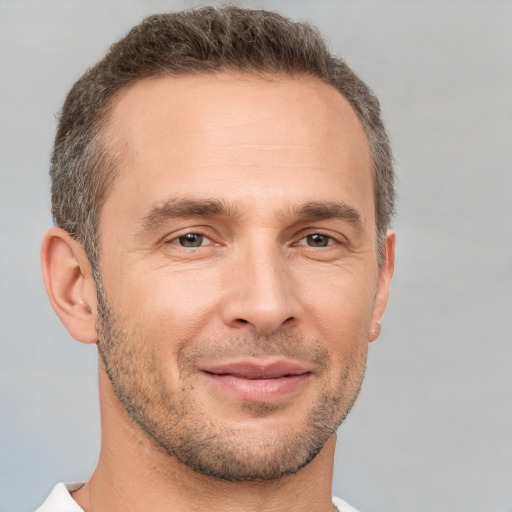 Joyful white adult male with short  brown hair and brown eyes