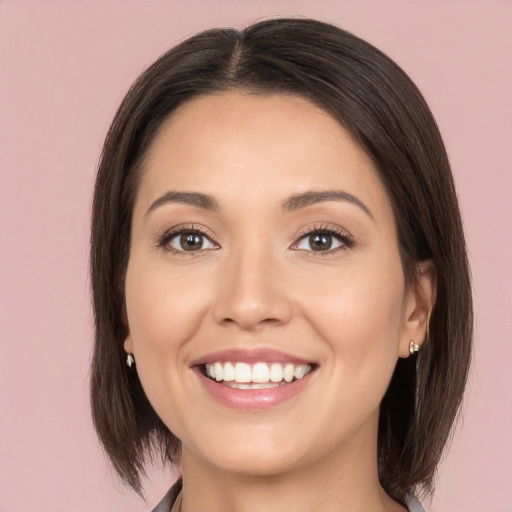 Joyful white young-adult female with medium  brown hair and brown eyes