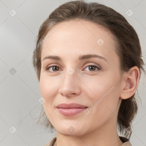 Joyful white young-adult female with medium  brown hair and grey eyes