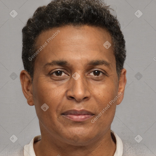 Joyful black adult male with short  brown hair and brown eyes
