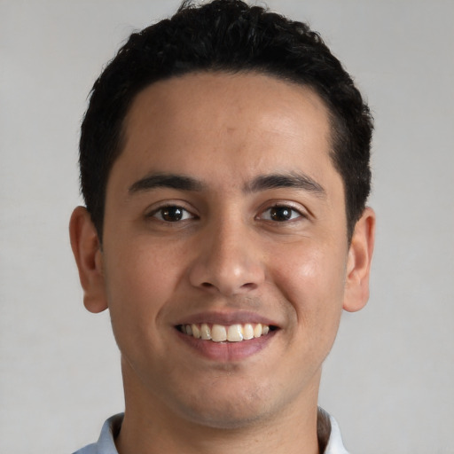 Joyful white young-adult male with short  black hair and brown eyes