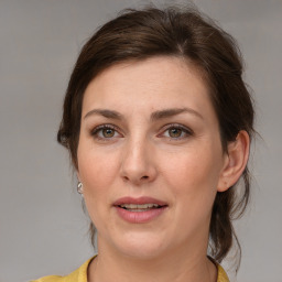 Joyful white adult female with medium  brown hair and brown eyes