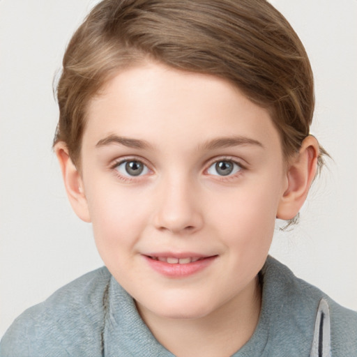 Joyful white child female with short  brown hair and blue eyes