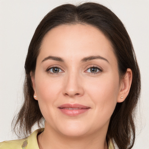 Joyful white young-adult female with medium  brown hair and brown eyes