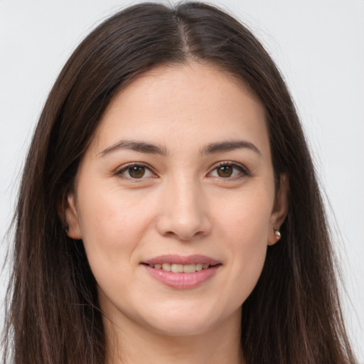 Joyful white young-adult female with long  brown hair and brown eyes