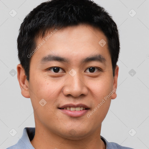 Joyful asian young-adult male with short  brown hair and brown eyes