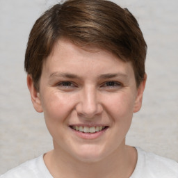 Joyful white young-adult female with short  brown hair and grey eyes