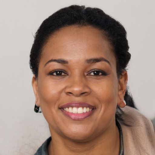 Joyful black adult female with short  brown hair and brown eyes