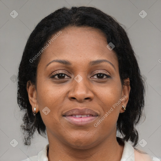 Joyful latino adult female with medium  brown hair and brown eyes