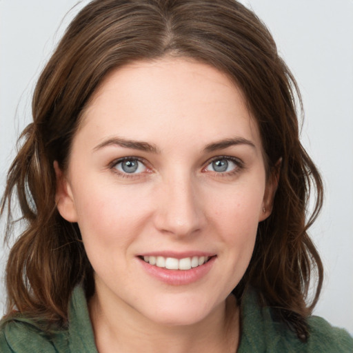 Joyful white young-adult female with medium  brown hair and green eyes