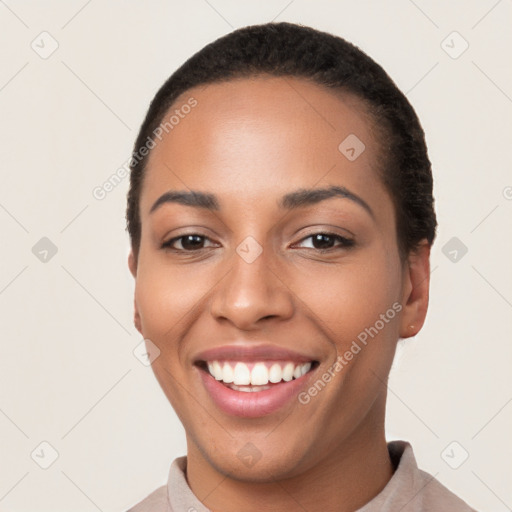 Joyful latino young-adult female with short  black hair and brown eyes