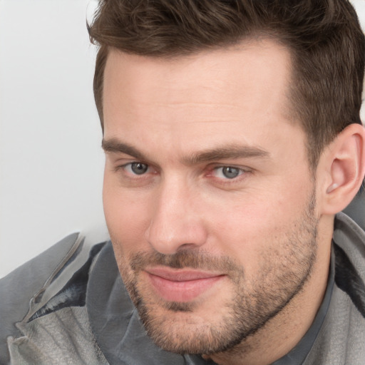 Joyful white adult male with short  brown hair and grey eyes