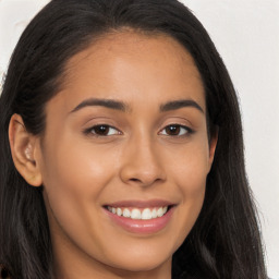 Joyful latino young-adult female with long  brown hair and brown eyes