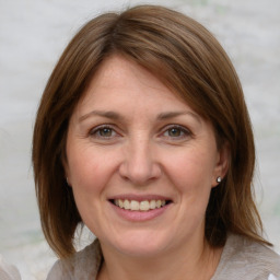 Joyful white adult female with medium  brown hair and grey eyes