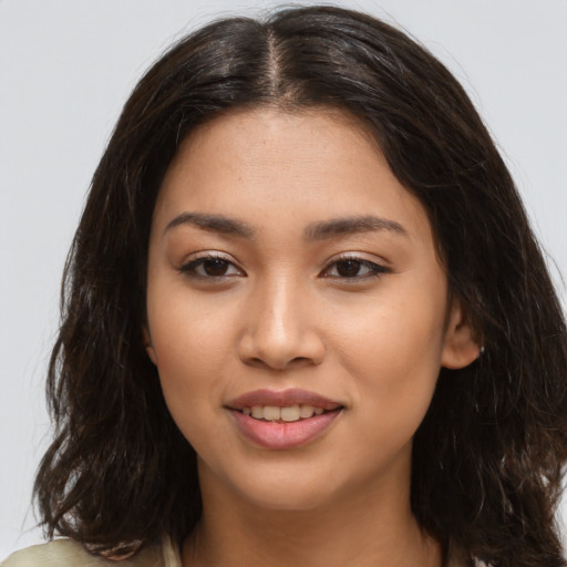 Joyful latino young-adult female with medium  brown hair and brown eyes