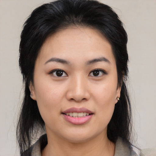 Joyful asian young-adult female with medium  black hair and brown eyes