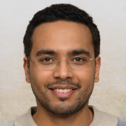 Joyful latino young-adult male with short  brown hair and brown eyes
