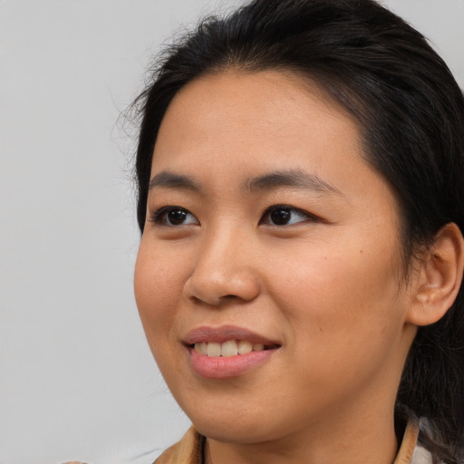 Joyful asian young-adult female with long  brown hair and brown eyes