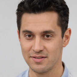 Joyful white adult male with short  brown hair and brown eyes