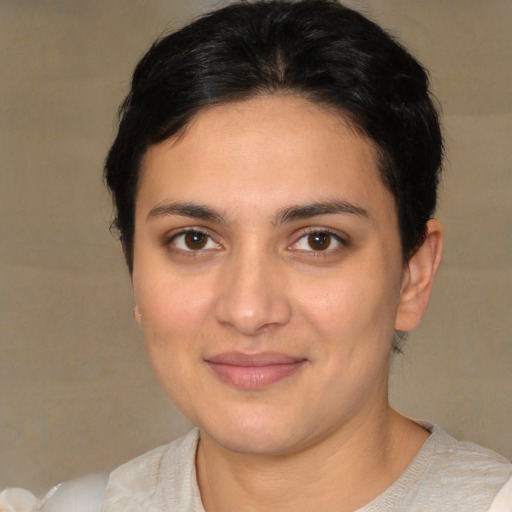 Joyful white young-adult female with short  brown hair and brown eyes