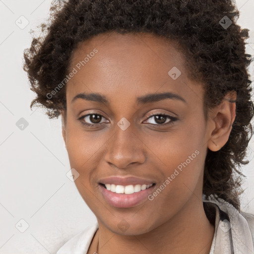 Joyful black young-adult female with long  brown hair and brown eyes