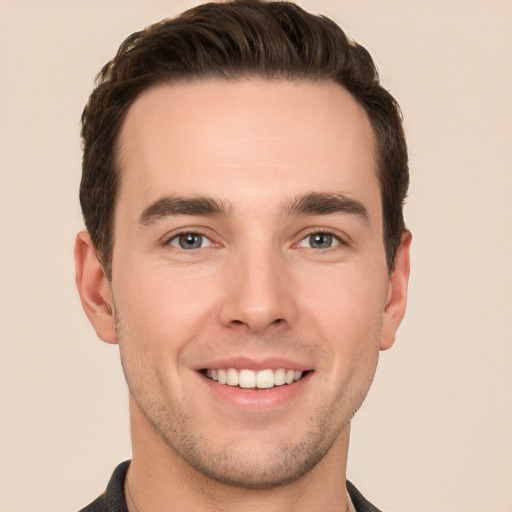 Joyful white young-adult male with short  brown hair and brown eyes