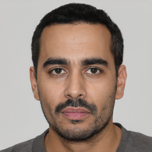 Neutral latino young-adult male with short  black hair and brown eyes