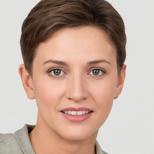 Joyful white young-adult female with short  brown hair and grey eyes