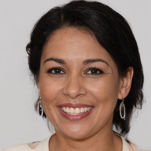 Joyful white adult female with medium  brown hair and brown eyes