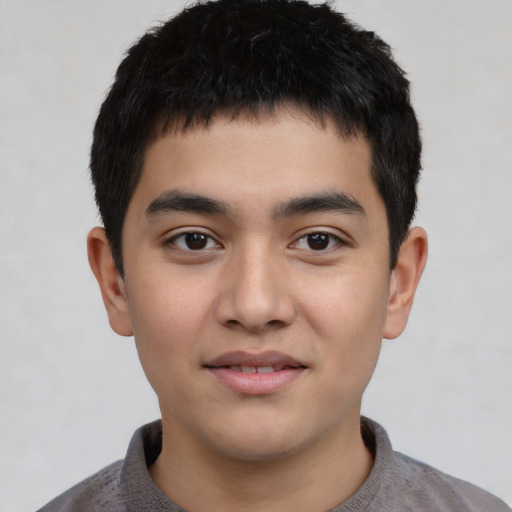 Joyful asian child male with short  black hair and brown eyes