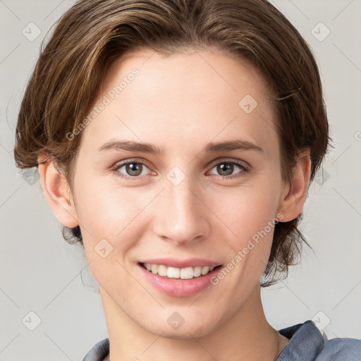 Joyful white young-adult female with medium  brown hair and grey eyes