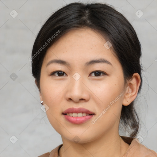 Joyful asian young-adult female with medium  black hair and brown eyes