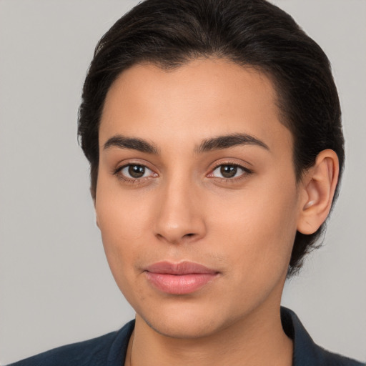 Joyful latino young-adult female with medium  brown hair and brown eyes