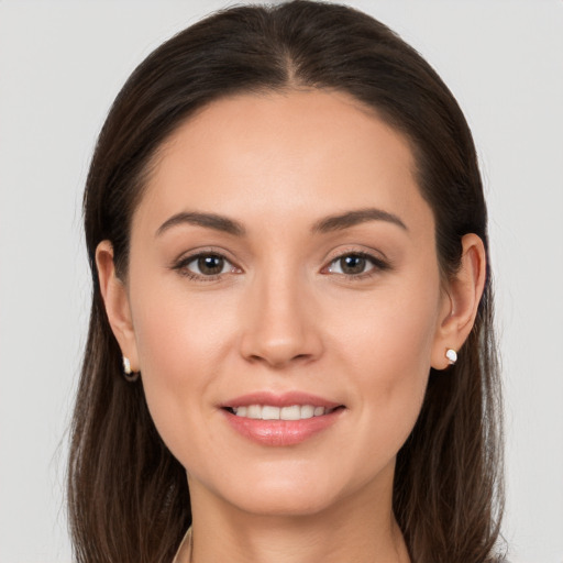 Joyful white young-adult female with long  brown hair and brown eyes