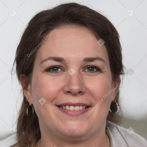 Joyful white adult female with medium  brown hair and brown eyes