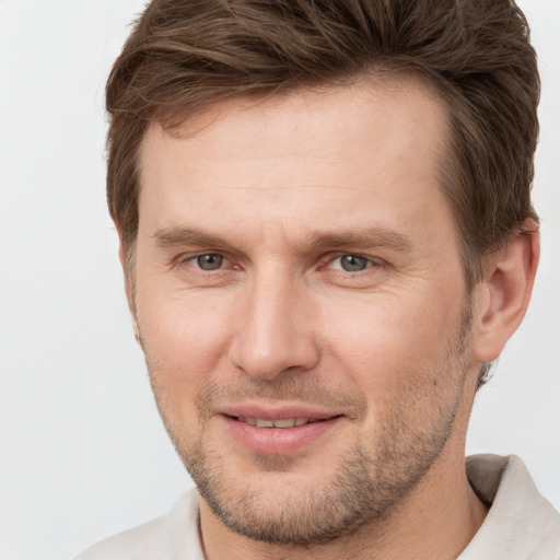 Joyful white adult male with short  brown hair and brown eyes