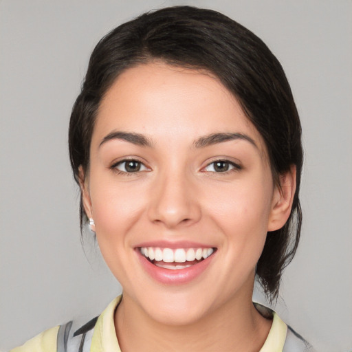 Joyful white young-adult female with medium  black hair and brown eyes