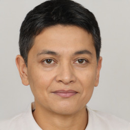 Joyful latino young-adult male with short  brown hair and brown eyes