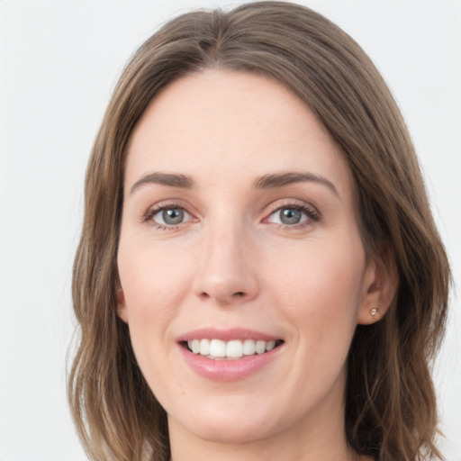 Joyful white young-adult female with long  brown hair and grey eyes