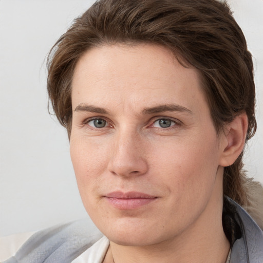 Joyful white young-adult female with short  brown hair and grey eyes