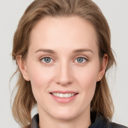 Joyful white young-adult female with medium  brown hair and blue eyes