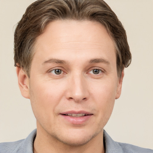 Joyful white adult male with short  brown hair and grey eyes