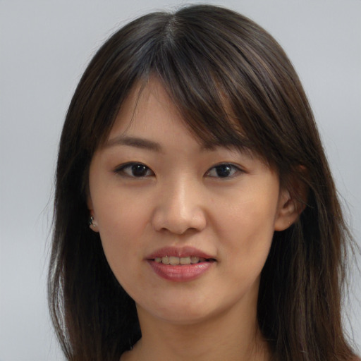 Joyful asian young-adult female with long  brown hair and brown eyes